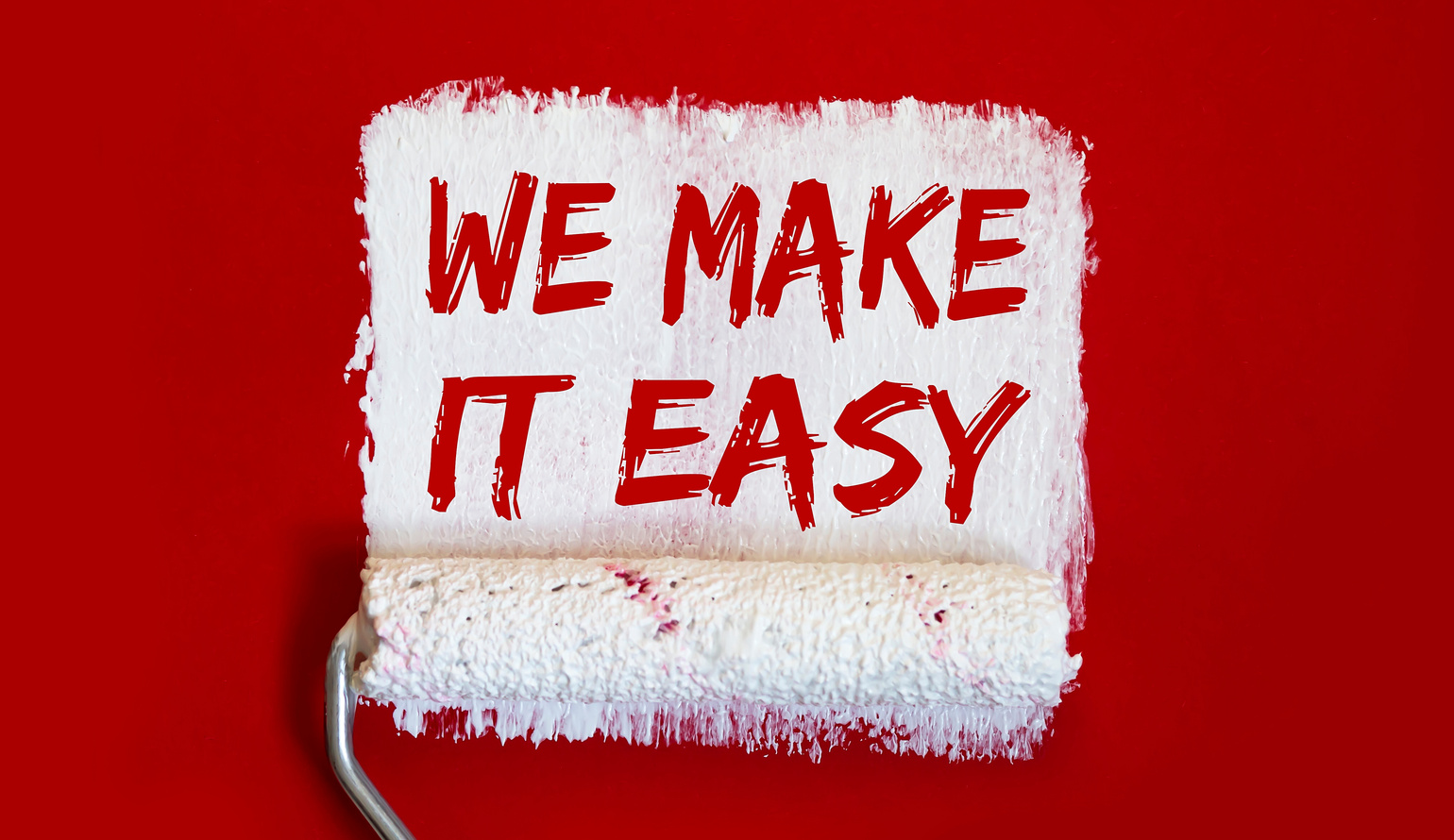 WE MAKE IT EASY .One open can of paint with white brush on red background. Top view.